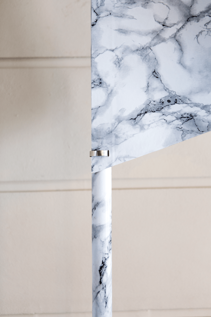 476 Promises (Distinction), 2017 
Carrara marble stones, self-adhesive marble imitation plastic foil, flag staff, 200 cm, cable binders
Exhibition view: 47.2120991° N 7.7892601° 